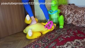 Nastya tramples on inflatable dinosaurs with her bare feet, destroying their weight. Crush fetish Foot fetish