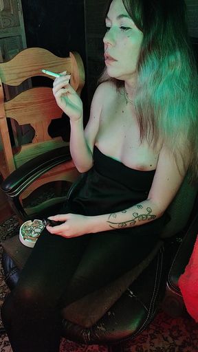 Mistress smokes a cigarette