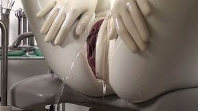 Latex lesbos examine each others wet muffs on a gynochair