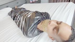 BABE AND BELLA CRUEL FARTING ON THE SLAVE TRAPPED IN PLASTIC WITH HIS MOUTH SEALED - CLIP 1