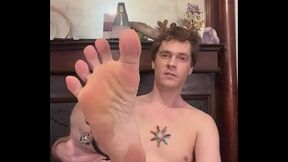 Daniel sticks his foot at the camera and shakes his bells