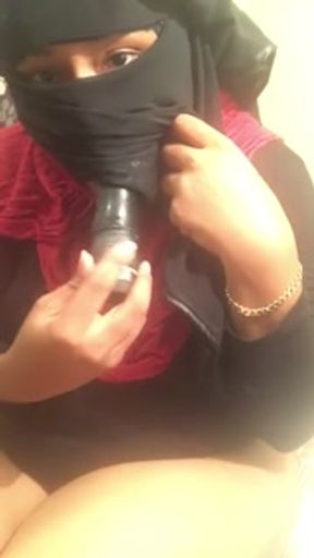 Lonely Hijabi niqabi woman masturbating fucking pussy with toy - feet out