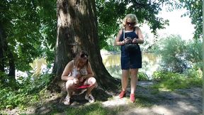 Two girls stopped on the side of the road to pee, attracting the attention of passing cars, golden shower in a public place