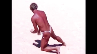 Suntanned stud on beach in lil wire panty temporarily