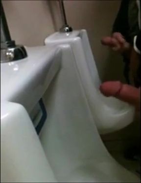 two slim dicks getting wanked at the urinals