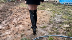 a beautiful thin girl in expensive high leather high heeled boots walks through the mud, in the end her new high heeled boots turn into a pile of mud