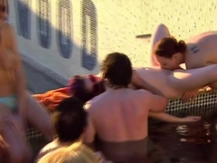 Oral sex in a pool party for a petite swinger brunette.