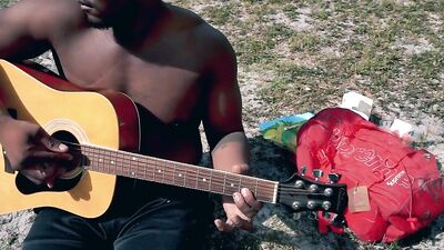 Diego Dawn is enjoying in a guitar in front of the camera