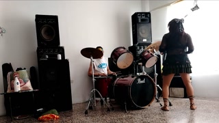 They play the drums for her - she dances, stripping and showing her ass