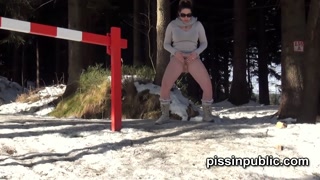Girls in need skate around in the snow to find a proper place to have a pee