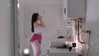 Amazingly beautiful college girl prepares for a night out with a short cut mini skirt to flash pussy