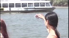 Teen girls are fucking each other with a clear dildo on the beach