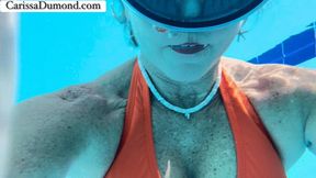 Carissa in the pool at the resort; swimming and blowing bubbles