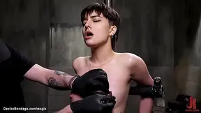 Bound in a predicament position gor short haired brunette babe Kristen Scott gets nipples clamped and hairy pussy fucked with dildo by master The Pope