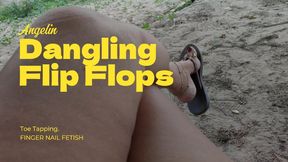 Cute feet holding hanging flip-flops while being swung (1)
