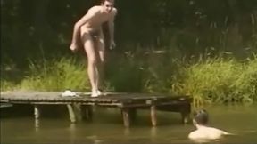 Young men skinny dip in a river.