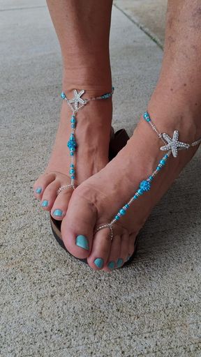 Cute, pedicured feet with matching barefoot sandals