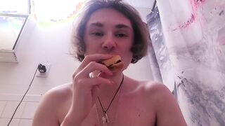 Bare woman gobbles burger while on the wc