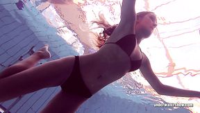 Long haired babe Lucy Gurchenko swimming in a pool