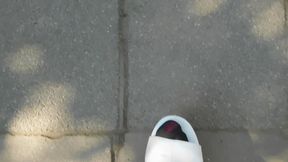 White mules and brown tights in the garden