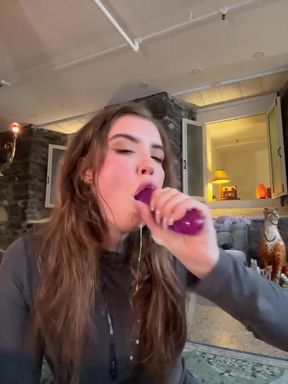 Hot babe plays with huge dildo in a cute solo blowjob scene