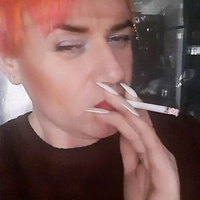 transvestite Sonyastar smokes, long nails, red hair