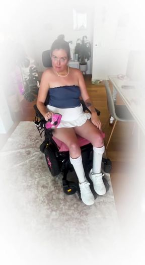 Woman in wheelchair with pink hair