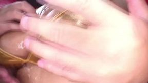 A Japanese woman rubs oil on her pussy so she can finger herself better, and a man rubs oil on her beautiful ass and fingers her pussy from behind.