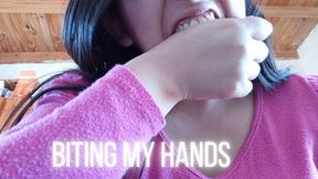 Lola biting her hands