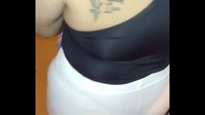 Rippled skin under see-through pants &mdash;  bold woman struts down the sidewalk