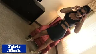 Ebony tattooed shemale stripteases strokes her cock in high heels