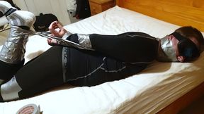 Miss M has a man completely duct taped in black compression gear