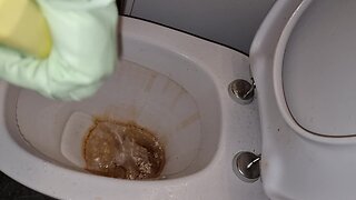 Hot man cleaning nasty toilet in rubber and leather