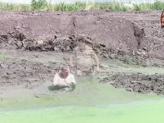Mudbath in darksome, creamy pond mud