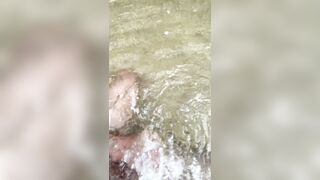 Draining off on the beach in thailand and nutting in the water. Public jack off