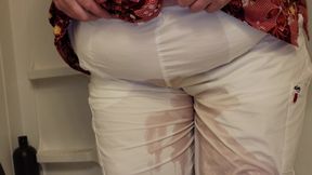 Molly is peeing her white nursing scrub pants.