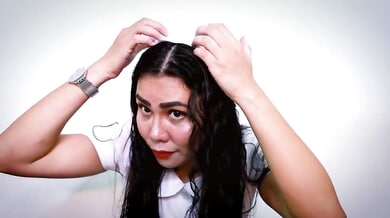 Submissive woman in green latex gloves performs an ASMR medical ritual