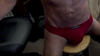 Grinding Stretch on Stool in red briefs for Pelvic Pain Relief and Myofascial Integration with Bulge and Butt and Chest and Belly