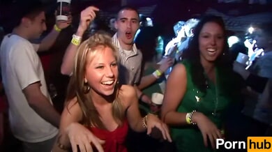Two wild party girls in lingerie tease the crowd at a neon-lit nightclub