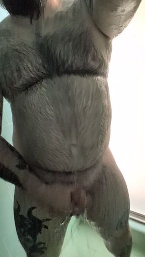 Hairy daddy wields a big uncut cock in shower