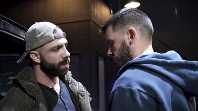 Bearded hunk fucks a guy next to a parked car outdoors