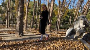 girl in white tights and ballet shoes has fun with fallen leaves, loses her shoes and gets her pantyhose dirty