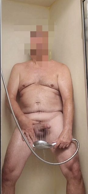 Exhibitionist masturbating with showerhead, stroking, cumming, and eating