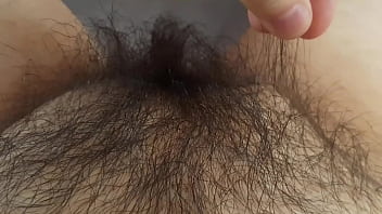 Stroking long black pussy hair alone in bed