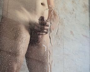 pissing behind the shower glass with uncut dick