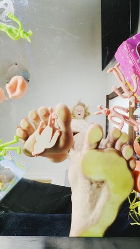 Barefoot Giant Stepping Tiny Easter Toys between Long Toes Glass View