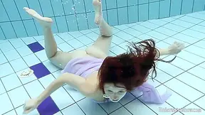 Floating Virgin Babe Swims And Strips Underwater