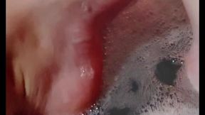 Hot blonde massaging her wet soapy feet in the bath