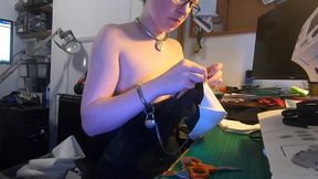 dutifully working away sewing face masks while plugged and corseted, with a tight hobble skirt on and my wrists chained toget...