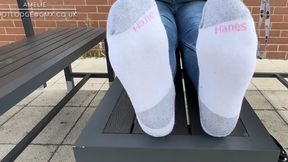 Shoeplay in ballet flats and dirty white Hanes socks